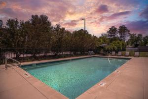 a swimming pool with a sunset in the background at Best Western Niceville-Destin in Niceville