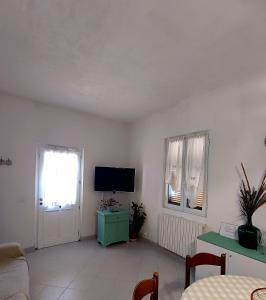a living room with a flat screen tv and a couch at Timo e Lavanda in Albenga
