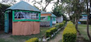 a small building with a playground in a park at DELIGACY RESORT Eldoret in Eldoret