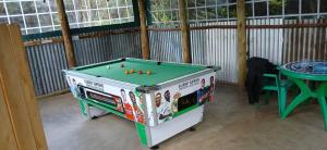 a pool table in a room with a table at DELIGACY RESORT Eldoret in Eldoret