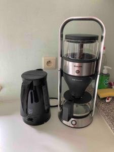 a coffee maker is sitting on a counter at Wahwo Baki in Wachtebeke
