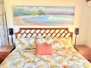 a bedroom with a bed with a painting on the wall at Best Ocean and Mountain View! in Waikoloa Village