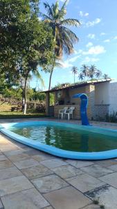 a swimming pool in a yard with a house at Kite House Barreiras in Macau