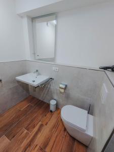 a bathroom with a white toilet and a sink at Apartment Gemini by Salzkammergood Living in Tauplitz