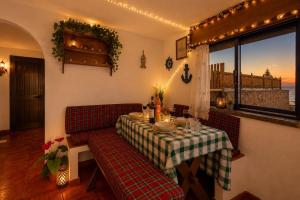 a dining room with a table and a view of the ocean at Casa sol e mar in Colares +20 photos