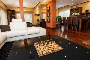 a living room with a couch and a chessboard on a table at New Play Lake Villa in Salou