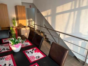 a dining room with two tables and chairs and a staircase at Pensiunea Florian in Tulcea