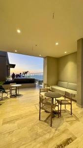 a living room with tables and chairs and a couch at Apartaestudio tipo loft cerca al mar in Santa Marta