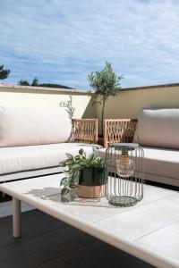 a coffee table with plants on a balcony at I&R Apartma in Hrpelje +27 photos