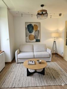 a living room with a couch and a coffee table at L'aparté Roussat in Langres
