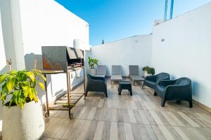 a room with chairs and a table on a balcony at Augusta Petit in Salta