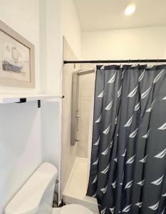 a bathroom with a toilet and a shower curtain at Casa Lux in Florida City