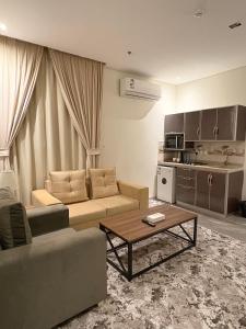 a living room with a couch and a coffee table at بريفير للشقق المخدومة - Privere Serviced Apartments in Riyadh
