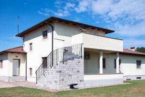 a white house with stairs in front of it at I&R Apartma in Hrpelje