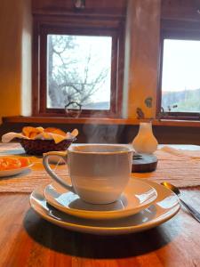 a coffee cup and saucer on a wooden table at Posada La Tregua in El Bolsón +27 photos