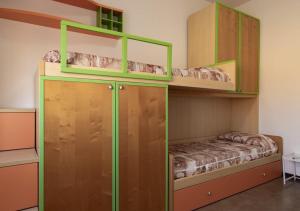 two bunk beds in a room with a bed at DaMaHouse in Monastir