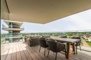 a dining room with a table and chairs on a balcony at Residence DeBlanke Top - 1D - Cadzand in Cadzand-Bad