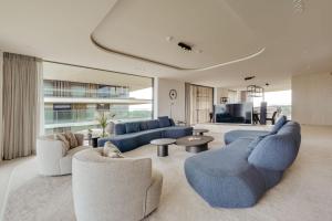 a large living room with blue couches and a tv at Residence DeBlanke Top - 1D - Cadzand in Cadzand-Bad