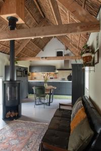 a living room with a couch and a fireplace at Gastenverblijf Begheynhof - your perfect escape in Biervliet
