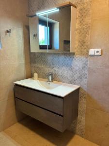 a bathroom with a sink and a mirror at Apartmán Madlen in Dolní Bobrová +16 photos