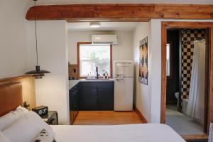 a kitchen with a refrigerator and a sink in a room at The Stranger Lodge - Pet Friendly in Sisters