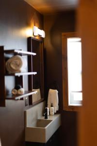 a bathroom with a sink and a mirror at The Stranger Lodge - Pet Friendly in Sisters +51 photos