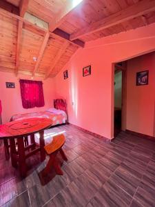 a room with a table and a bed and a table at El rinconcito in Omitlán de Juárez