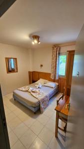 a bedroom with two beds and a window at Auberge du Coustet in Saint-Léger