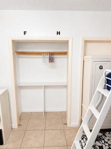 a room with a white closet with a ladder at Miami City Hostel in Miami