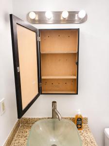 a bathroom with a sink and a mirror at Miami City Hostel in Miami +24 photos