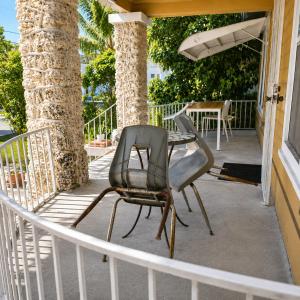 a patio with two chairs and a table on a porch at Miami City Hostel in Miami