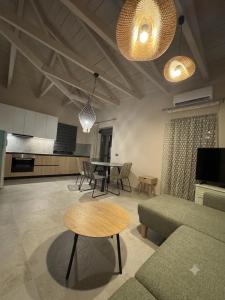 a living room with a couch and a table at Geamare Studios in Kálamos