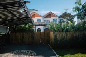a fence in front of a house with a building at D'Muarra Studio Villa in Cemagi +18 photos