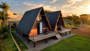 an image of a tiny house with a black roof at Chalés JH Serra da Canastra in São Roque de Minas