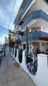 a white fence in front of a building at Kiki by the sea Villa in Paralia Katerinis