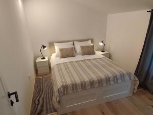 a bedroom with a bed and two lamps on night stands at Casa Colone in Bale +24 photos