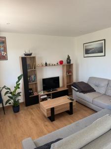 a living room with a couch and a coffee table at Bidart, maisonnette sur les Pyrénées in Bidart