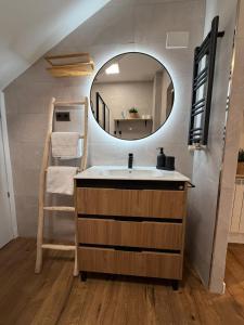 a bathroom with a sink and a mirror at La Flor in El Molar
