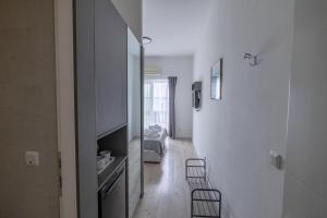 a room with a hallway with a bed and a mirror at Apartments Marin in Podstrana