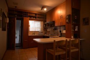 a kitchen with wooden cabinets and a counter top at Sleep to the Sound of Waves - Full Private Apartment in Swakopmund