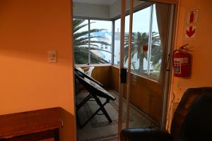 a door to a room with a view of a balcony at Sleep to the Sound of Waves - Full Private Apartment in Swakopmund