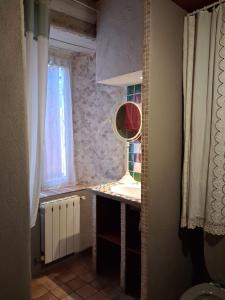 a small kitchen with a table and a window at Le mas des Anglades in Saint-André-de-Valborgne