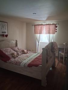 a bedroom with a bed and a window at Le mas des Anglades in Saint-André-de-Valborgne