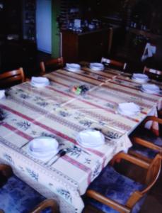 a table with plates and bowls on top of it at Regina de la Montania in Pajići