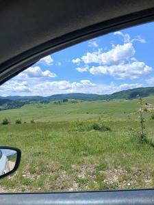 a view of a field from a car window at Regina de la Montania in Pajići
