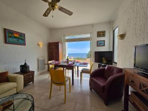 a living room with a table and a dining room at Villa Vue Panoramique sur les îles de Lérins in Saint-Raphaël