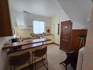 a kitchen with a counter and some chairs in it at Villa Vue Panoramique sur les îles de Lérins in Saint-Raphaël