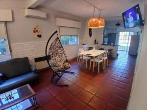 a living room with a table and a dining room at Casa Quinta Marie Rose in Mercedes