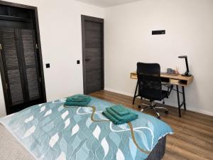 a bedroom with a bed with a desk and a chair at Baltijos Apartamentai, Self check-in, free parking in Klaipėda