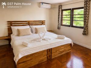 a bedroom with a large bed with white sheets at Oceanside Place in Rayong +53 photos